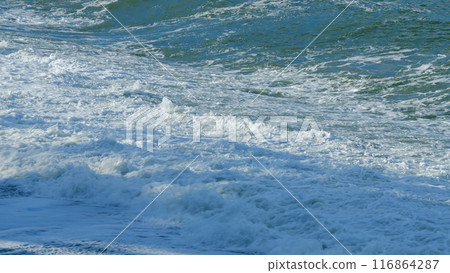 Beach Is Covered With Pebbles. Small Sea Waves. Waves Crashing On A Beach. Still. Beach Is Covered With Pebbles. Small Sea Waves. Waves Crashing On A Beach. Still. 116864287