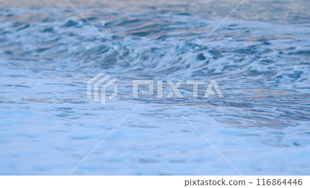 Sea Wave With Blue Water Of Ocean Crashing. Waves Coming Into The Beach At Sunset. Summer Beach Nature. Static view. Sea Wave With Blue Water Of Ocean Crashing. Waves Coming Into The Beach At Sunset. Summer Beach Nature. Static view. 116864446