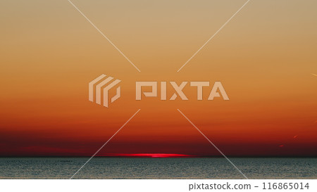 Sunrise Or Sunset In Seaside Beautiful. Beautiful Golden Orange Sunset Over Ocean. Slow motion. Sunrise Or Sunset In Seaside Beautiful. Beautiful Golden Orange Sunset Over Ocean. Slow motion. 116865014