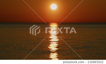 Travel Beginning. Ocean Water And Dramatic Sun Down Sea Waterscape. Summer Sunset Seascape. Slow motion. Travel Beginning. Ocean Water And Dramatic Sun Down Sea Waterscape. Summer Sunset Seascape. Slow motion. 116865022