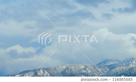 Nature Background. Snowy Mountain Top With A White Clouds Moving In With Blue Sky In The Background. Timelapse. Nature Background. Snowy Mountain Top With A White Clouds Moving In With Blue Sky In The Background. Timelapse. 116865085