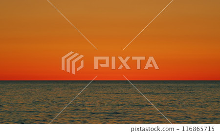 Color Of Sunlight In Sky Reflecting In Sea Water. Orange And Red Tones Reflects In Ocean. Slow motion. Color Of Sunlight In Sky Reflecting In Sea Water. Orange And Red Tones Reflects In Ocean. Slow motion. 116865715