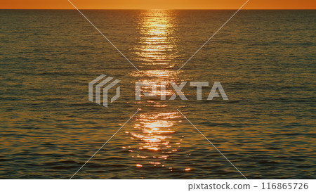 Tropical Colorful Sunset. Sun Glare With Small Waves On Water Surface. Abstract Nautical Nature. Slow motion. Tropical Colorful Sunset. Sun Glare With Small Waves On Water Surface. Abstract Nautical Nature. Slow motion. 116865726