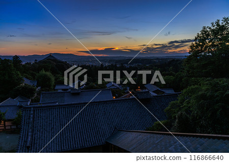 Summer 2024 Evening view of Nigatsudo Hall at Todaiji Temple in Nara. The western sky gradually darkens. Beautiful sunset sky ranging from golden to deep blue. 116866640