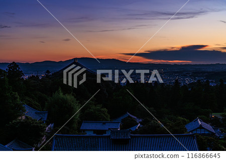 Summer 2024 evening view of Nigatsudo Hall at Todaiji Temple in Nara. The western sky gradually darkens. The sky changes from vermilion to deep blue and the temple grounds are lit up. Summer 2024 evening view of Nigatsudo Hall at Todaiji Temple in Nara. The western sky gradually darkens. The sky changes from vermilion to deep blue and the temple grounds are lit up. 116866645
