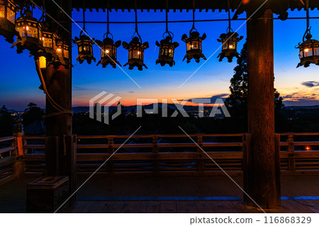 Summer 2024 Evening view of Nigatsudo Hall, Todaiji Temple, Nara Beautiful sunset sky seen through the lit lanterns on the stage Wide angle ② 116868329
