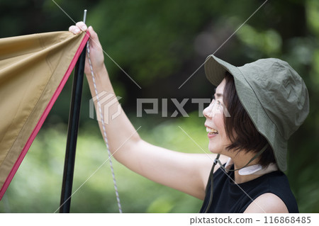 Close-up profile of a woman enjoying the outdoors at a campsite Solo camping 116868485