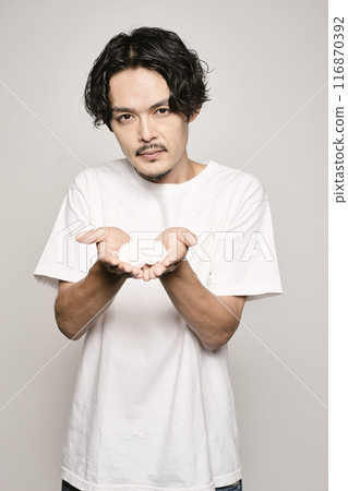 A man washing his face on a white background 116870392