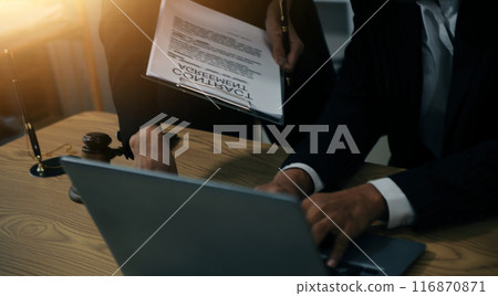 Judge gavel with Justice lawyers having team meeting at law firm background. Concepts of Law and Legal services. 116870871