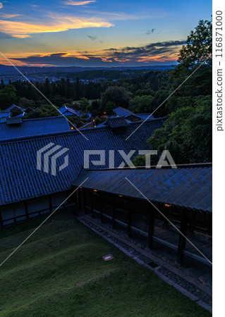 Summer 2024 evening view of Nigatsudo Hall in Nara - The sun setting over the Todaiji Temple grounds, painting the western sky golden. Summer 2024 evening view of Nigatsudo Hall in Nara - The sun setting over the Todaiji Temple grounds, painting the western sky golden. 116871000