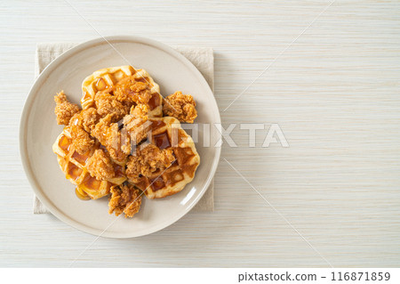 fried chicken waffle with honey or maple syrup 116871859