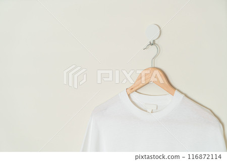 t-shirt hanging with wood hanger 116872114