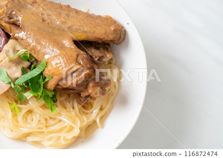 dried noodles with braised duck in white bowl 116872474