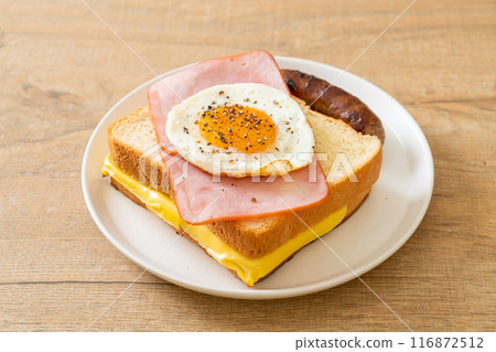 bread toasted cheese topped ham and fried egg with pork sausage 116872512