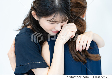 Two women hugging Two women hugging 116872575