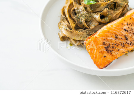 pesto fettuccine spaghetti pasta with grilled salmon fillet pesto fettuccine spaghetti pasta with grilled salmon fillet 116872617