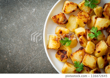 Roasted or grilled potatoes  on plate 116872645