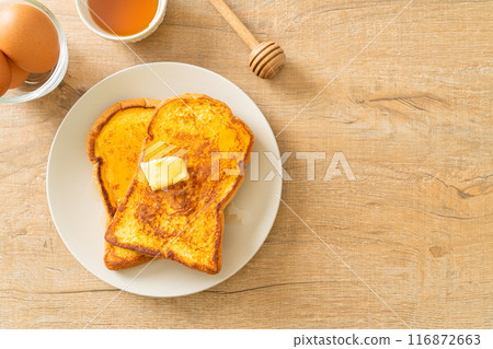 French toasted with butter and honey 116872663
