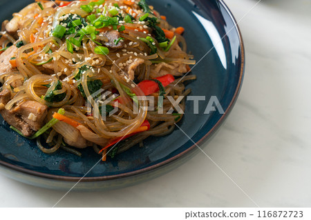 japchae or stir-fried Korean vermicelli noodles with vegetables and pork topped with white sesame 116872723