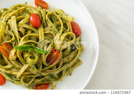 fettuccine spaghetti pasta with pesto sauce and tomatoes fettuccine spaghetti pasta with pesto sauce and tomatoes 116872987