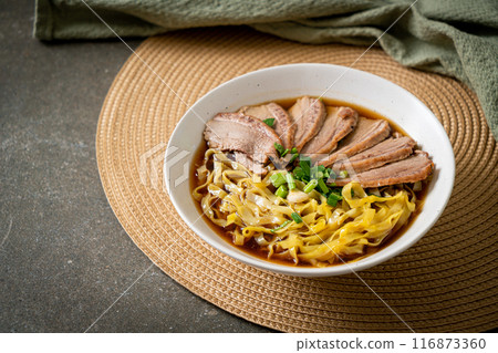 egg noodles with stewed duck in brown soup 116873360