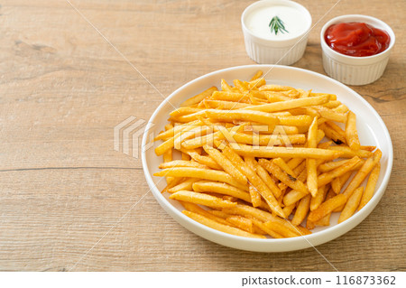 French fries with sour cream and ketchup 116873362