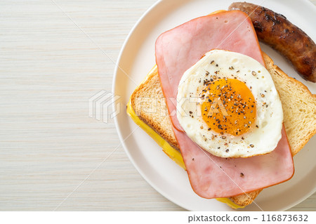 bread toasted cheese topped ham and fried egg with pork sausage 116873632