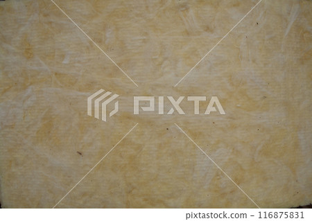 Construction worker thermally insulating house mineral wool attic with glass wool 116875831