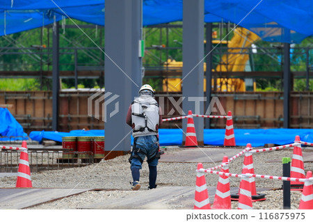 A person working at a construction site 116875975