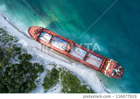 Aerial top down view of an abandoned bulk-carrier dry cargo ship washed ashore after a storm Aerial top down view of an abandoned bulk-carrier dry cargo ship washed ashore after a storm 116877828