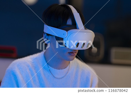 Young man wearing VR goggles Young man wearing VR goggles 116878042