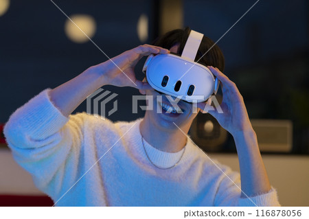 Young man wearing VR goggles Young man wearing VR goggles 116878056