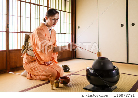 A foreign woman in a kimono performing a tea ceremony A foreign woman in a kimono performing a tea ceremony 116878781
