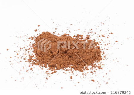 Cocoa powder scattered on white background close-up Cocoa powder scattered on white background close-up 116879245