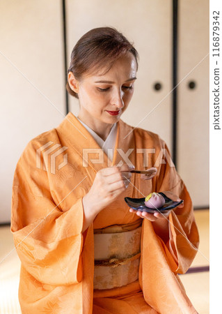 A foreign woman in a kimono being treated to sweets A foreign woman in a kimono being treated to sweets 116879342