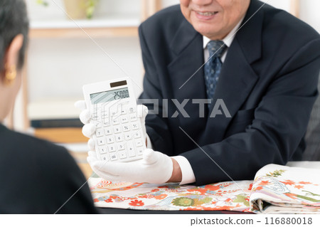 Man assessing recycling, calculator in hand Man assessing recycling, calculator in hand 116880018