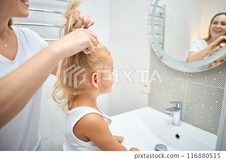 Mother and daughter child girl are combing Mother and daughter child girl are combing 116880515