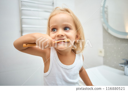 Morning routine, smiling happy child brushing teeth with toothbrush. Morning routine, smiling happy child brushing teeth with toothbrush. 116880521