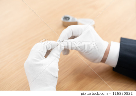 A man examining something with a magnifying glass 116880821