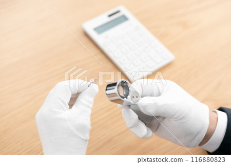 A man examining something with a magnifying glass 116880823