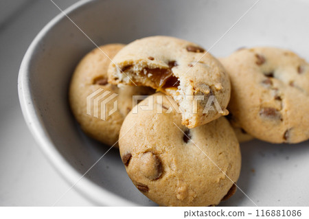 American Twix soft cookies with chocolate and caramel drops in white bowl 116881086