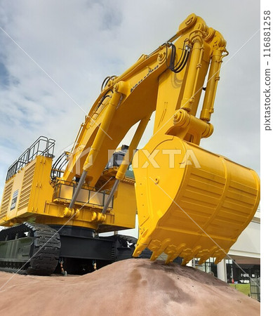 Shovel scooping sand 116881258