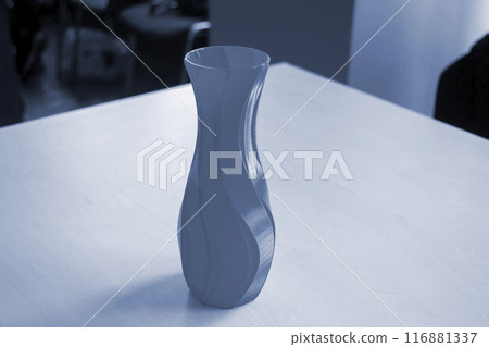 Object in the form of a vase printed on a 3D printer. Three-dimensional model printed on a 3D printer from molten plastic. Concept 3D Printing. FDM 3D Printing technology Object in the form of a vase printed on a 3D printer. Three-dimensional model printed on a 3D printer from molten plastic. Concept 3D Printing. FDM 3D Printing technology 116881337