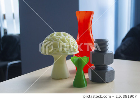 Several art multi-colored objects printed on a 3D printer. Model red vase, white mushroom, green tip, gray washer and bolt created 3D printer from molten plastic. Additive progressive technology Several art multi-colored objects printed on a 3D printer. Model red vase, white mushroom, green tip, gray washer and bolt created 3D printer from molten plastic. Additive progressive technology 116881907