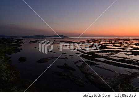 Sunset on the island in front of the oil well Sunset on the island in front of the oil well 116882359