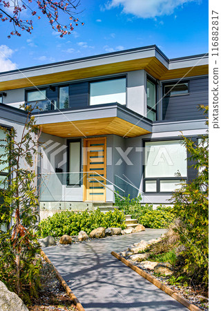 Neat entrance of modern residential house on blue sky background Neat entrance of modern residential house on blue sky background 116882817
