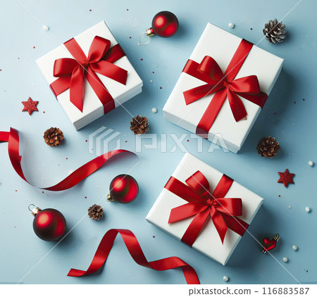 Three white gift boxes with red satin ribbons on a blue background. Gifts for Christmas, New Year, Valentine's Day, Birthday Three white gift boxes with red satin ribbons on a blue background. Gifts for Christmas, New Year, Valentine's Day, Birthday 116883587