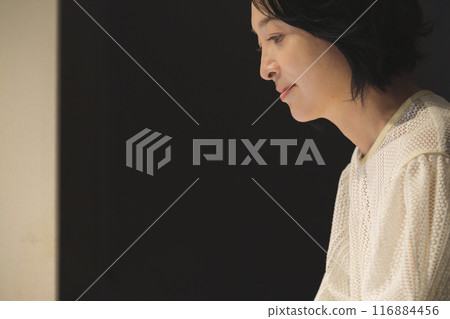 晚上用電腦工作的中年婦女 晚上用電腦工作的中年婦女 116884456