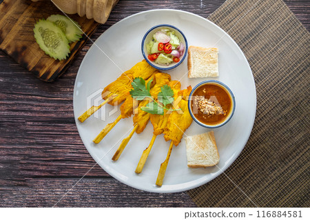 Chicken Satay served with peanut sauce and sweet sour sauce - Asian food Concept style on white plate Chicken Satay served with peanut sauce and sweet sour sauce - Asian food Concept style on white plate 116884581