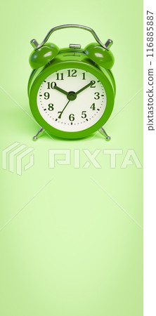 Green Alarm Clock on Green Background with Copy Space Green Alarm Clock on Green Background with Copy Space 116885887